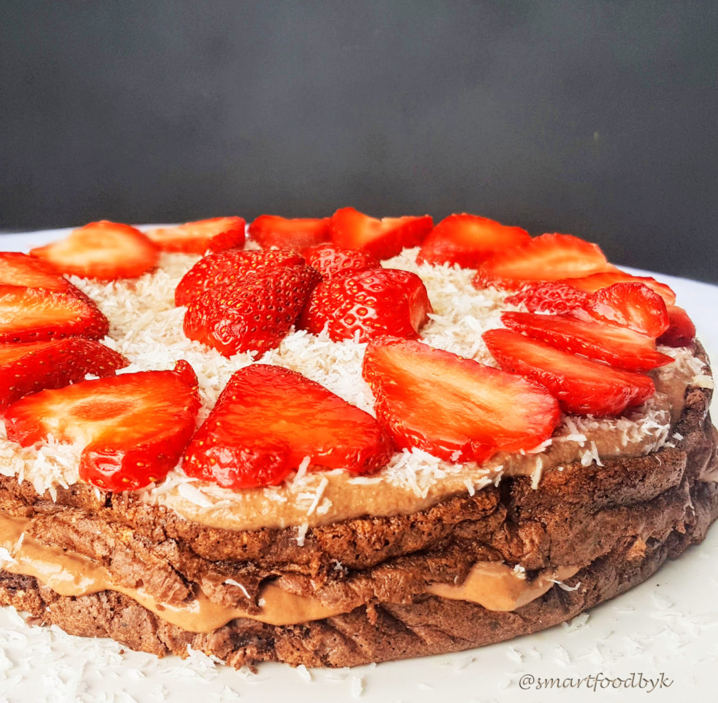 Low-calorie dark chocolate cake with coconut cream and strawberries