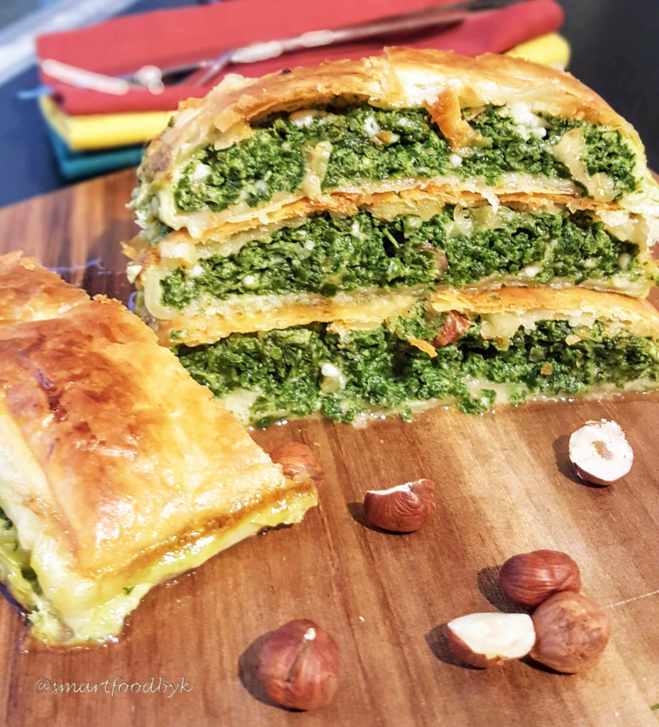 Spinach puff pastry roll with ricotta and hazelnuts