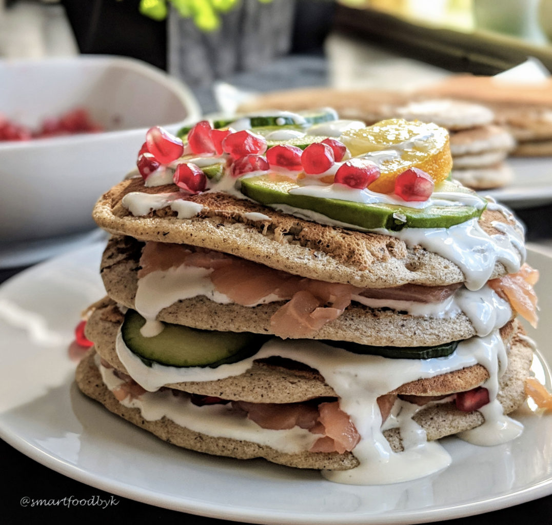 Savoury pancakes with salmon, cucumber, avocado & pomegranate