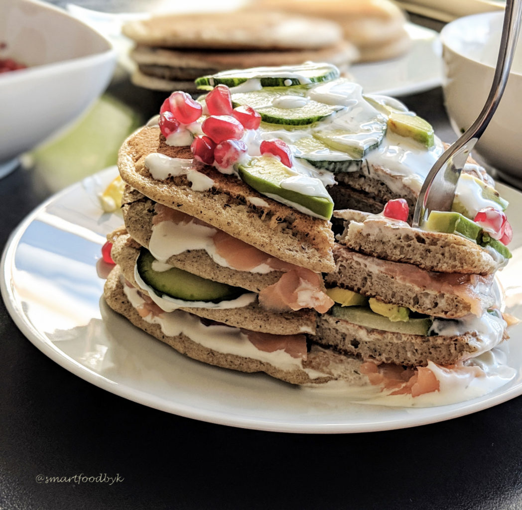 Savoury pancakes with salmon, cucumber, avocado and pomegranate. 