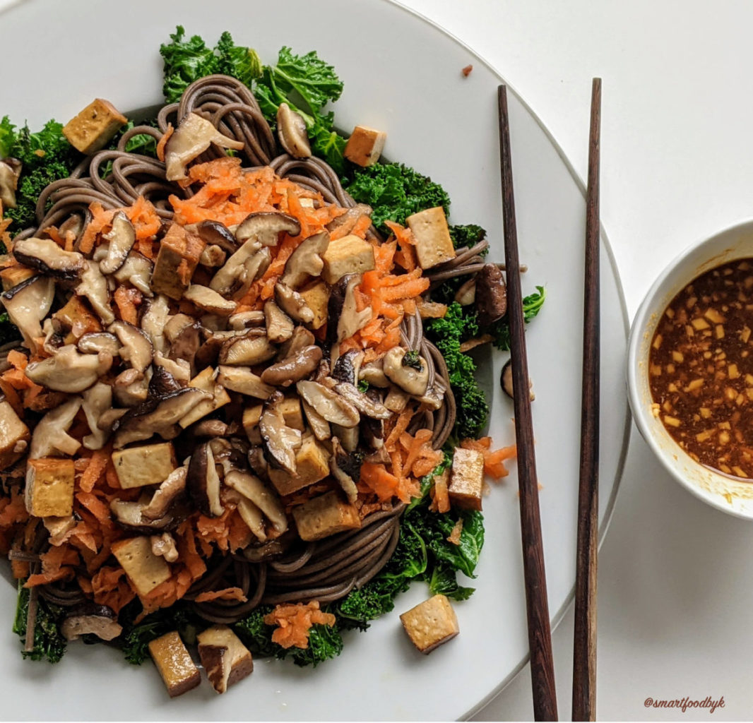 Soba noodle bowl with sautéd kale, shiitake, smoked tofu and raw grated carrot. Plus the secret sauce.